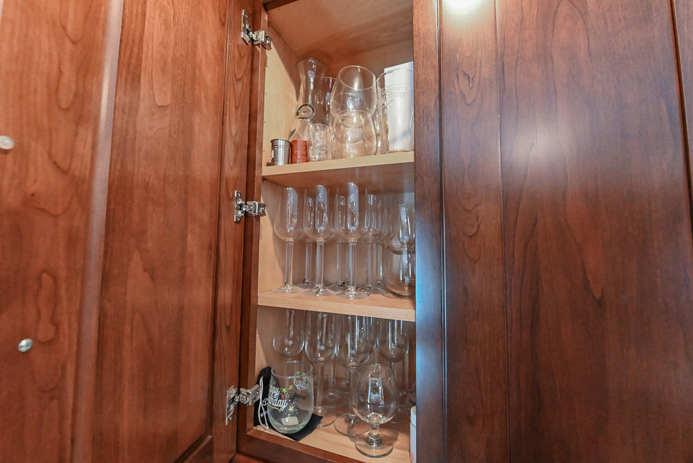 Kraftmaid Transitional Dark Wooden Kitchen with Marble Countertops and GE Monogram Appliances