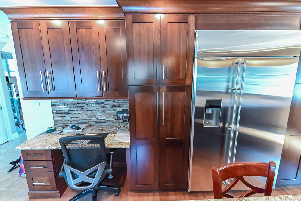 Kraftmaid Transitional Dark Wooden Kitchen with Marble Countertops and GE Monogram Appliances