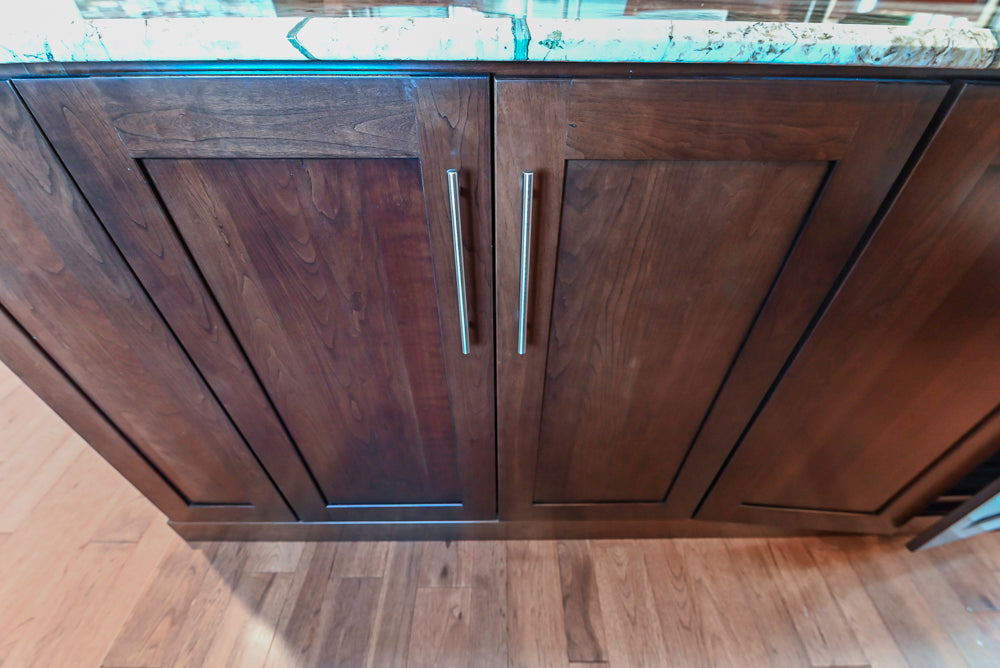 Kraftmaid Transitional Dark Wooden Kitchen with Marble Countertops and GE Monogram Appliances