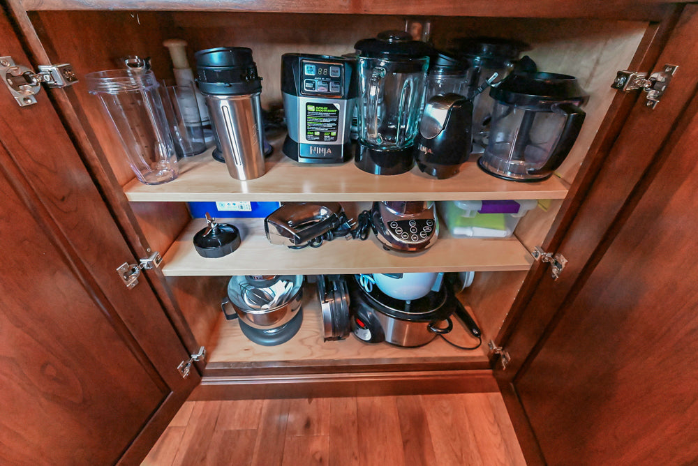 Kraftmaid Transitional Dark Wooden Kitchen with Marble Countertops and GE Monogram Appliances