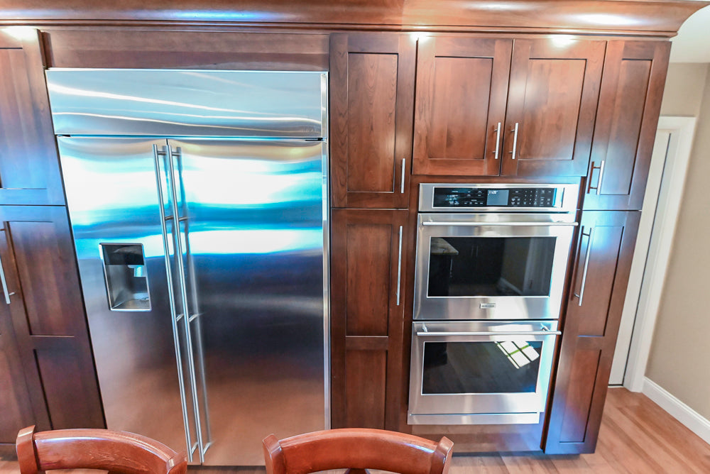 Kraftmaid Transitional Dark Wooden Kitchen with Marble Countertops and GE Monogram Appliances