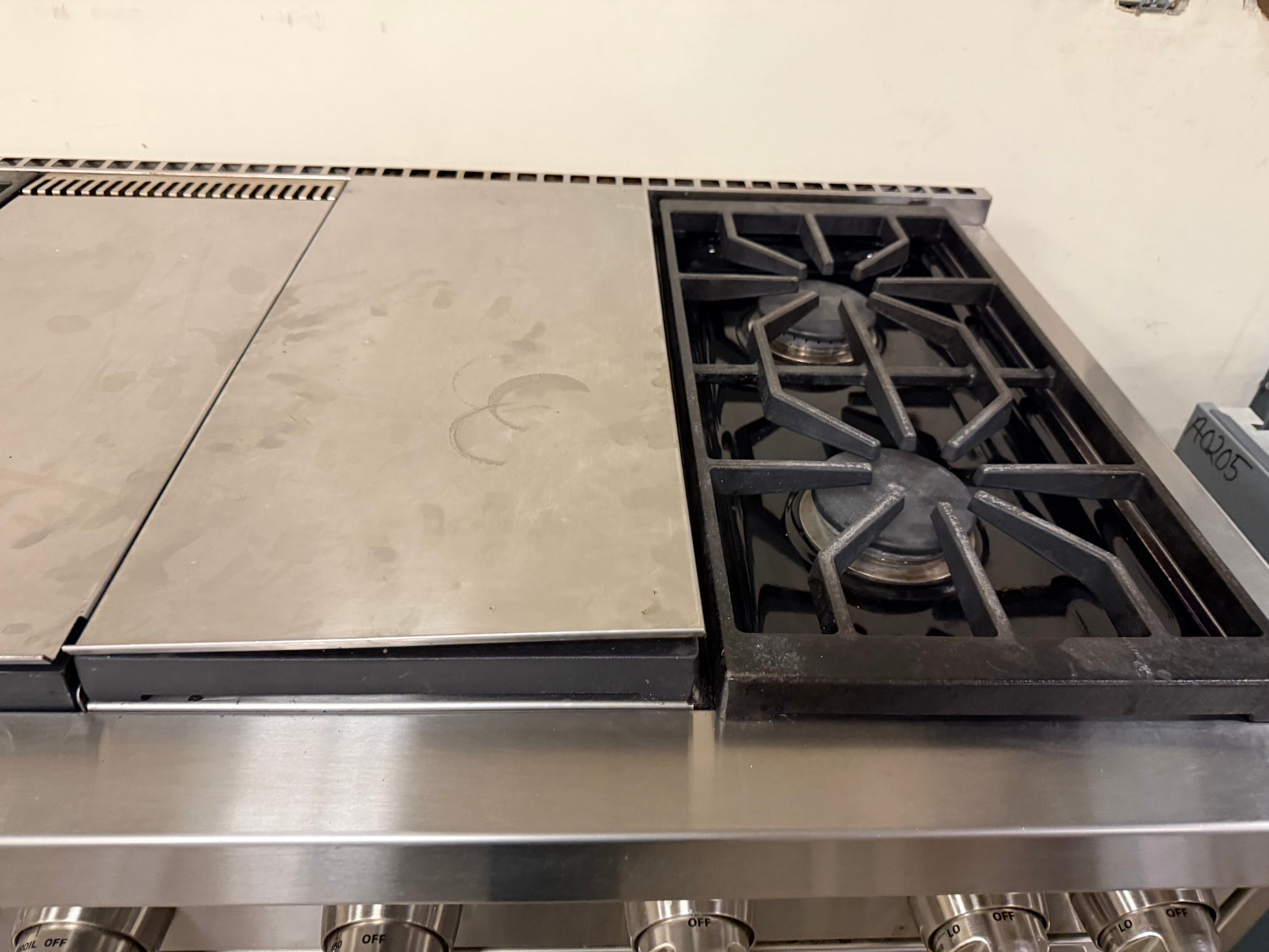 Detailed shot of the Wolf dual-stacked gas burners designed for precise flame control from simmer to boil.