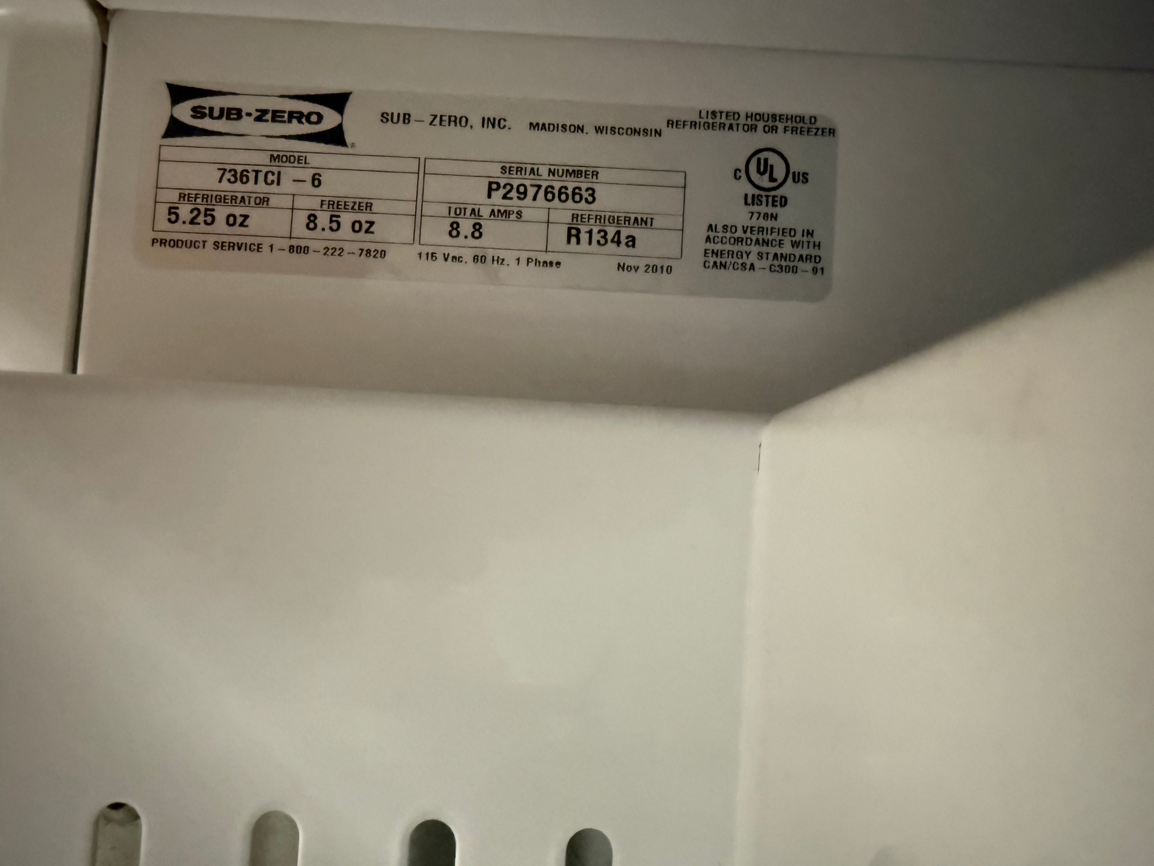 Back of a white appliance with a label on a gray background