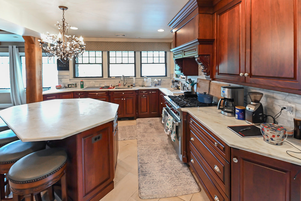 Custom Traditional Dark Wooden Kitchen with Marble Countertops and Wolf Appliances