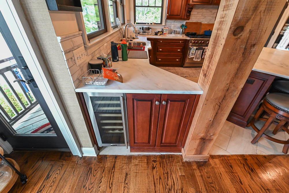 Custom Traditional Dark Wooden Kitchen with Marble Countertops and Wolf Appliances