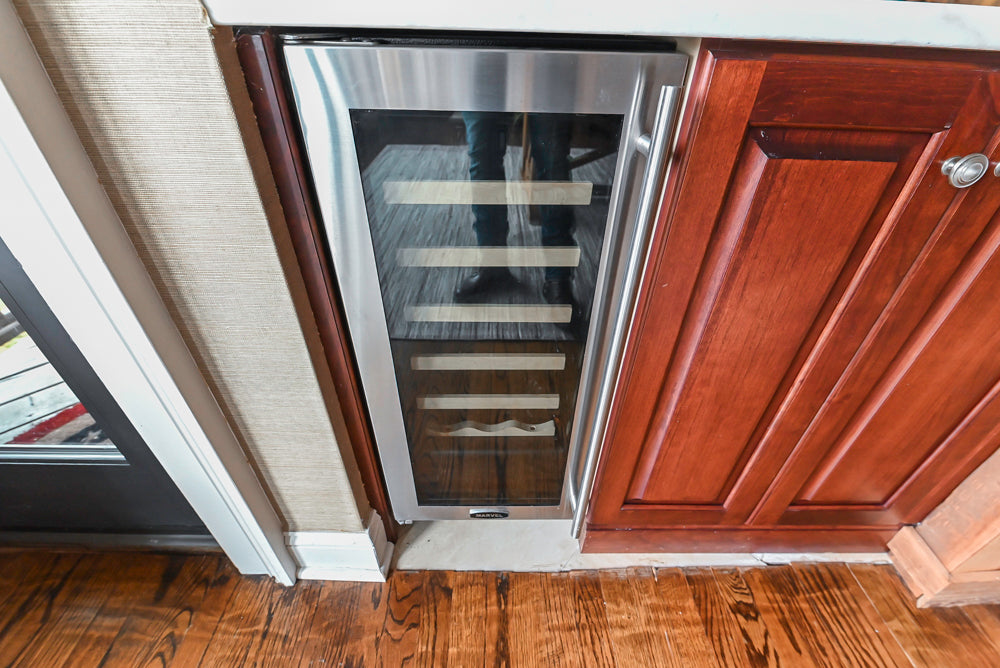 Custom Traditional Dark Wooden Kitchen with Marble Countertops and Wolf Appliances