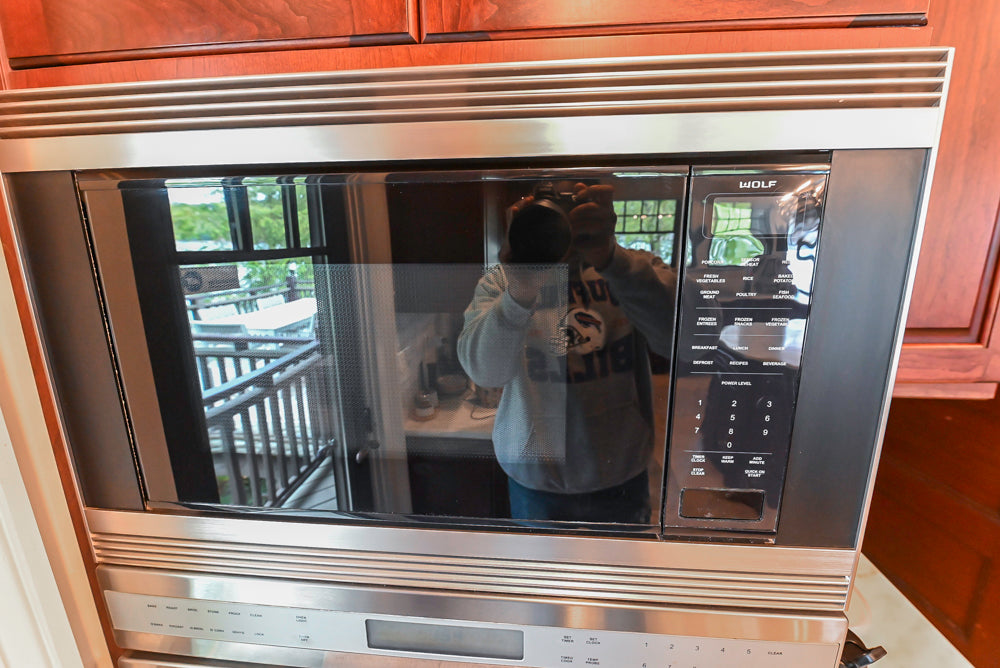 Custom Traditional Dark Wooden Kitchen with Marble Countertops and Wolf Appliances