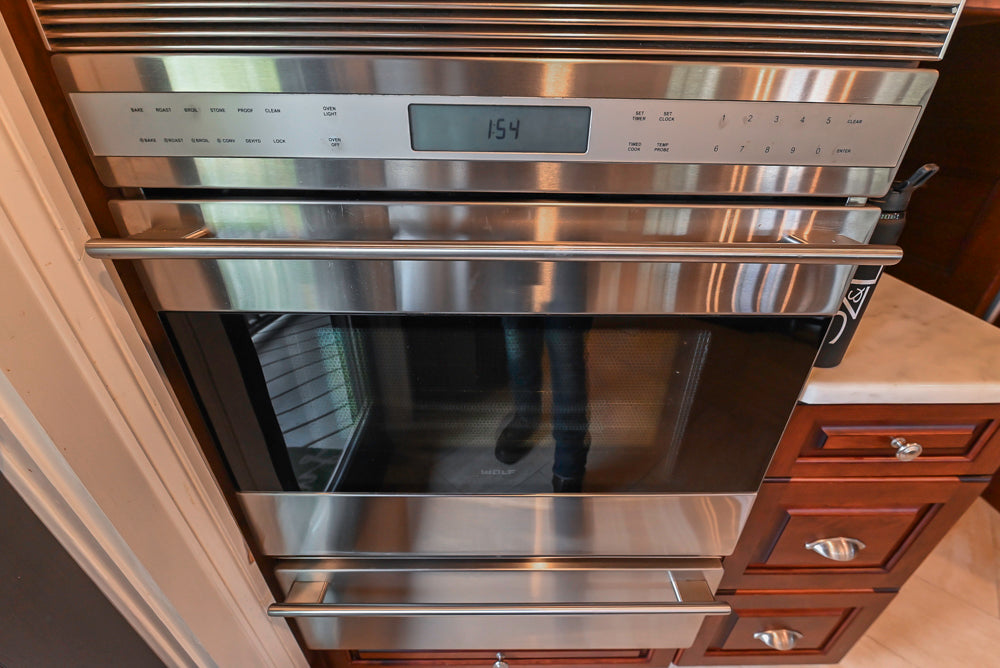 Custom Traditional Dark Wooden Kitchen with Marble Countertops and Wolf Appliances