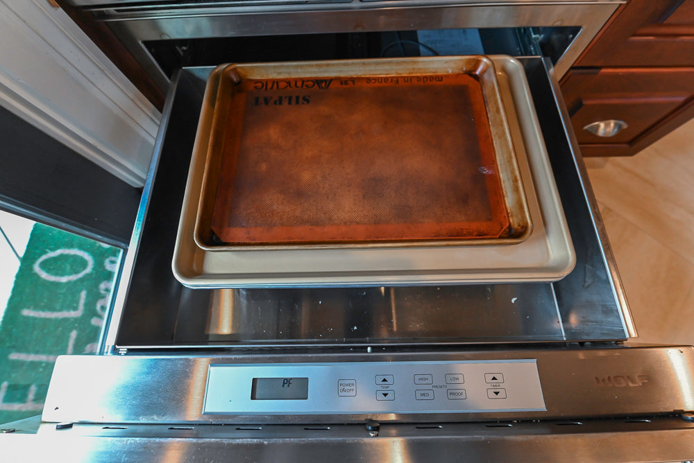 Custom Traditional Dark Wooden Kitchen with Marble Countertops and Wolf Appliances