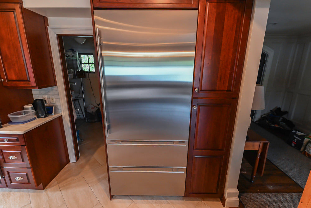 Custom Traditional Dark Wooden Kitchen with Marble Countertops and Wolf Appliances
