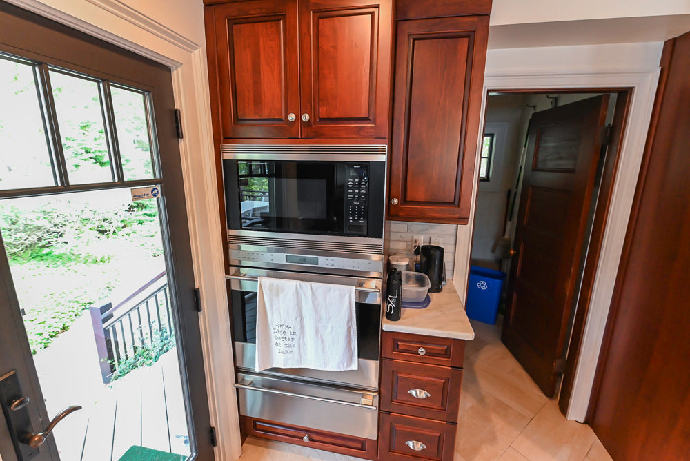 Custom Traditional Dark Wooden Kitchen with Marble Countertops and Wolf Appliances