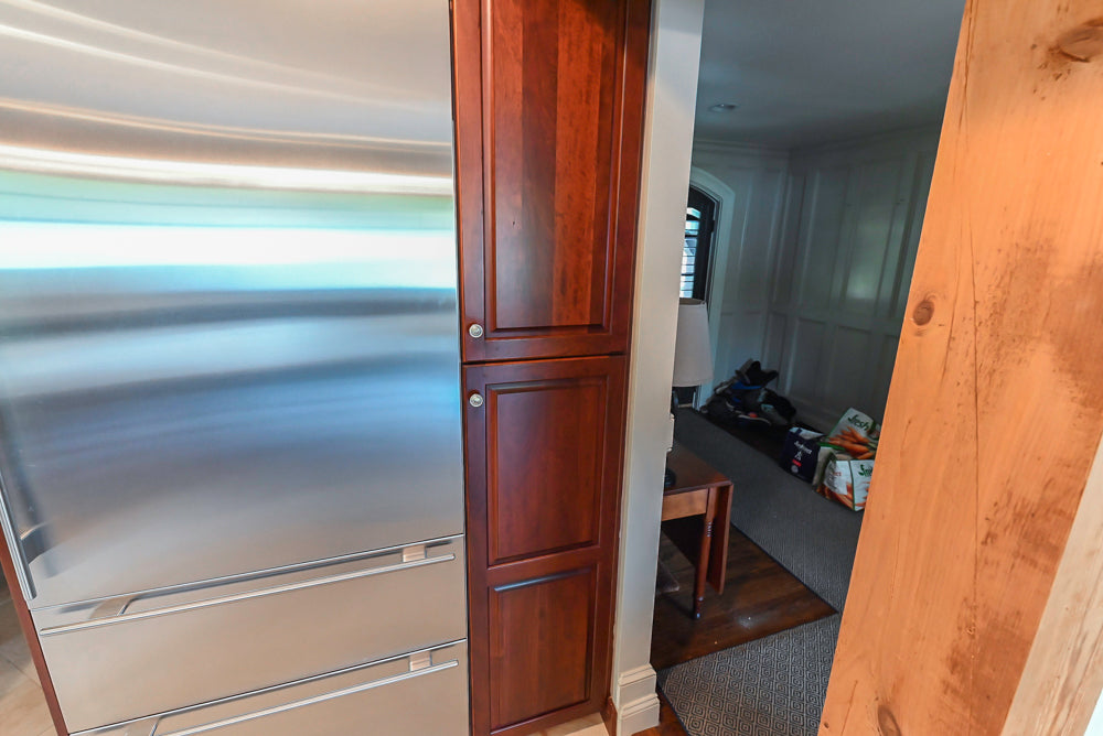 Custom Traditional Dark Wooden Kitchen with Marble Countertops and Wolf Appliances
