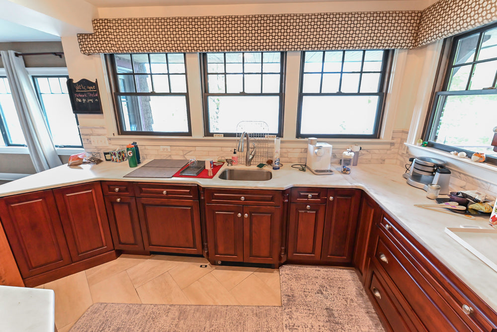 Custom Traditional Dark Wooden Kitchen with Marble Countertops and Wolf Appliances