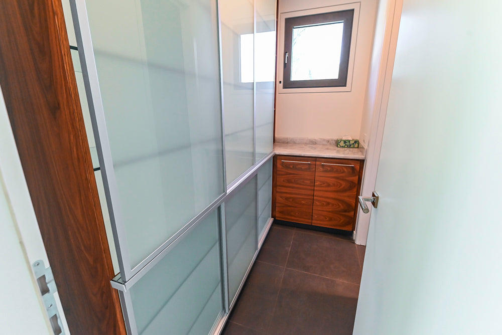 Custom Modern Tigerwood & Glass Paned Butler's Pantry with Marble Countertops