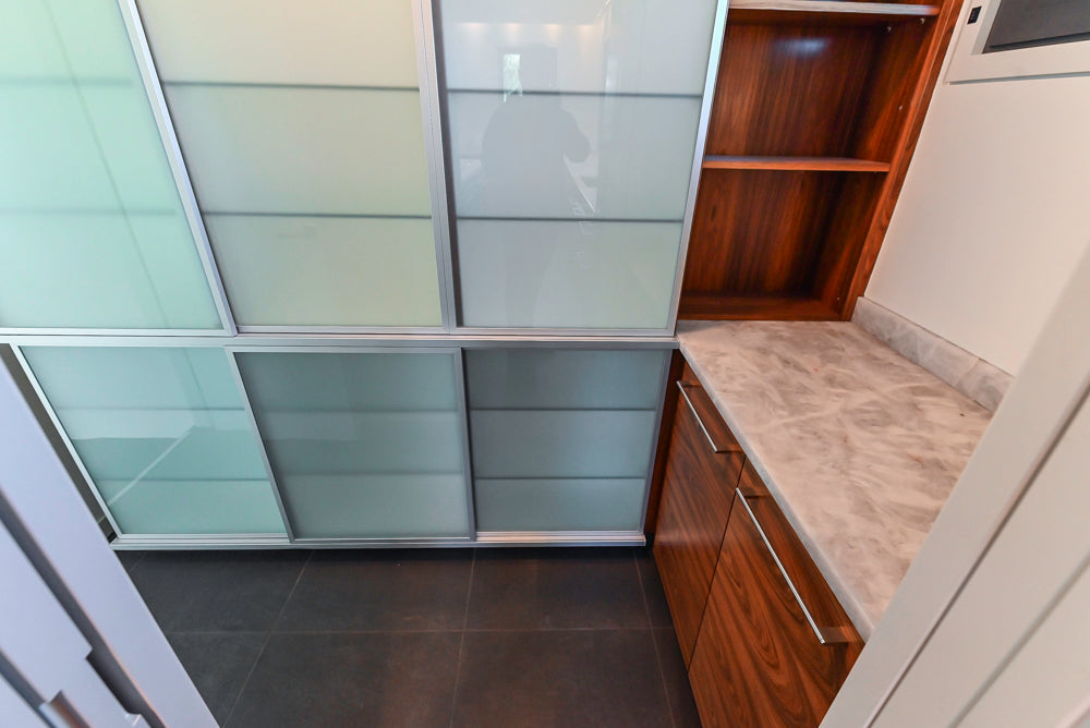 Custom Modern Tigerwood & Glass Paned Butler's Pantry with Marble Countertops