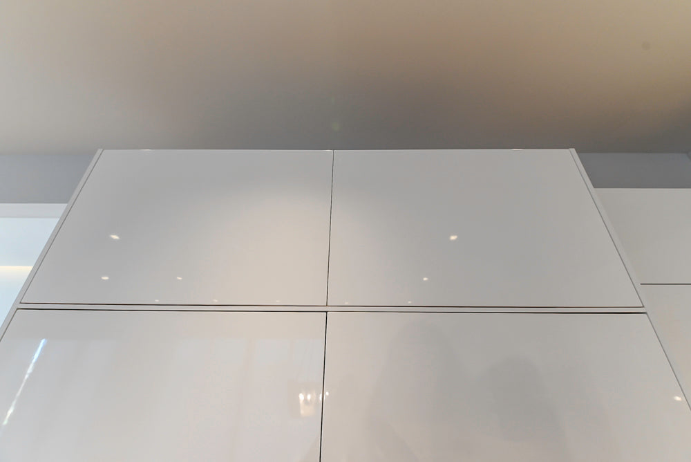 Brubaker Modern White Lacquered Kitchen with Waterfall Island and Stone Countertops