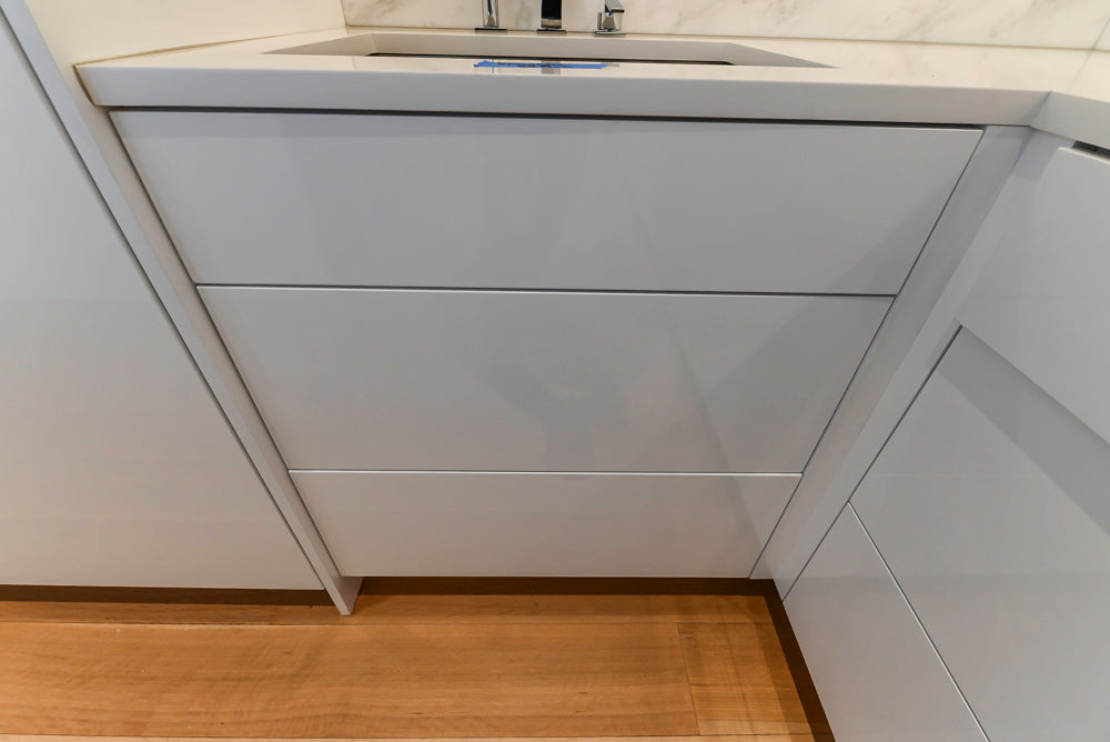 Brubaker Modern White Lacquered Kitchen with Waterfall Island and Stone Countertops