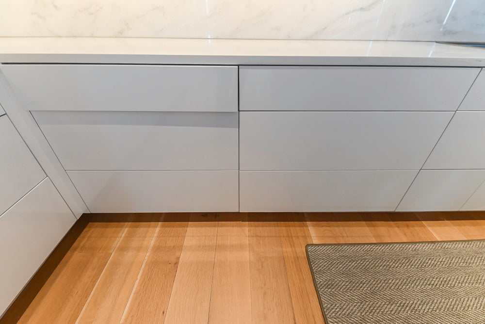 Brubaker Modern White Lacquered Kitchen with Waterfall Island and Stone Countertops