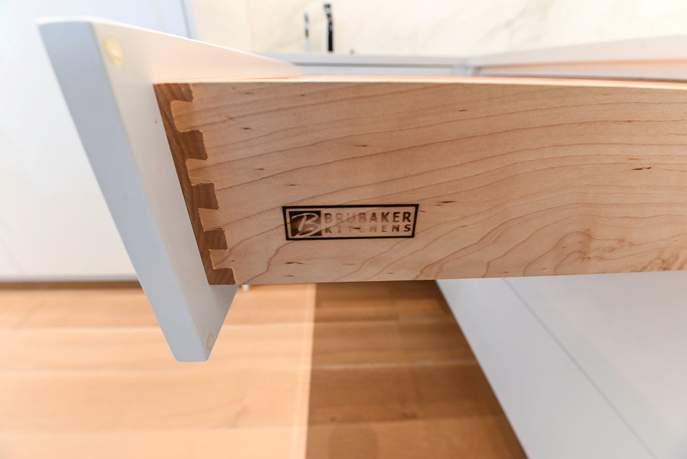 Brubaker Modern White Lacquered Kitchen with Waterfall Island and Stone Countertops