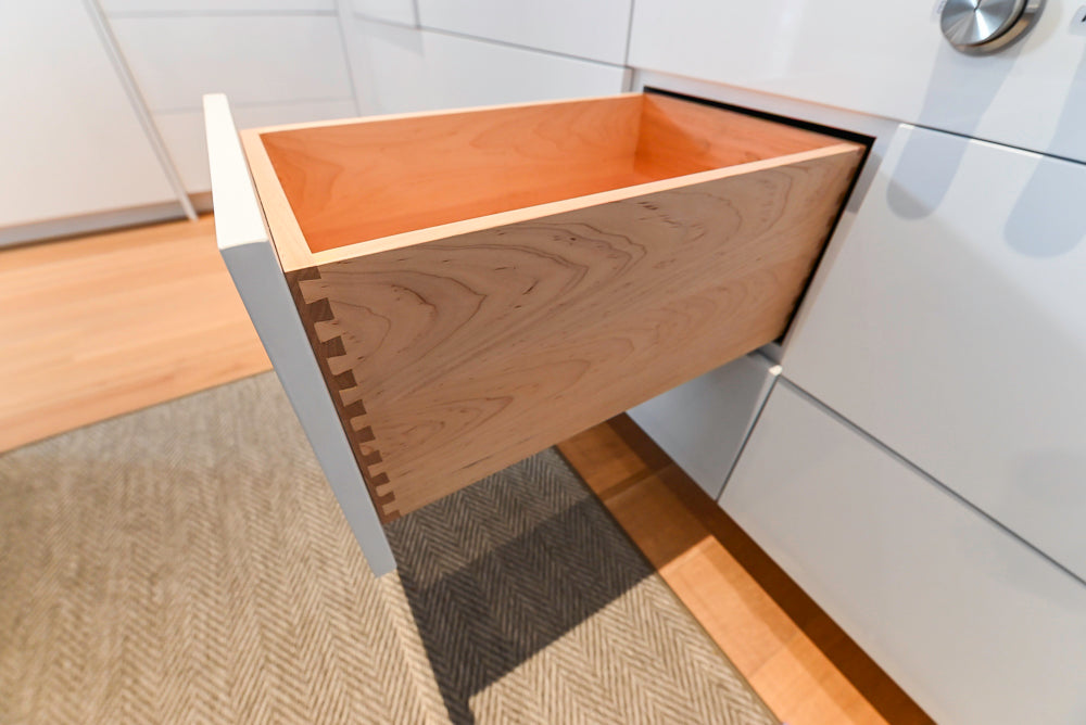 Brubaker Modern White Lacquered Kitchen with Waterfall Island and Stone Countertops