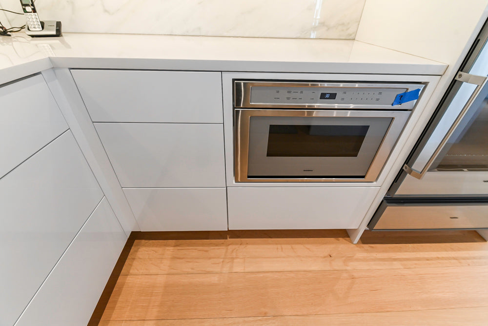 Brubaker Modern White Lacquered Kitchen with Waterfall Island and Stone Countertops