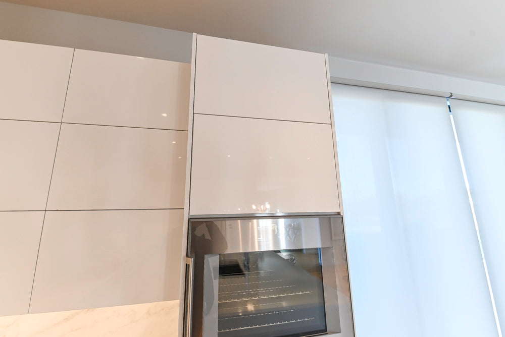 Brubaker Modern White Lacquered Kitchen with Waterfall Island and Stone Countertops