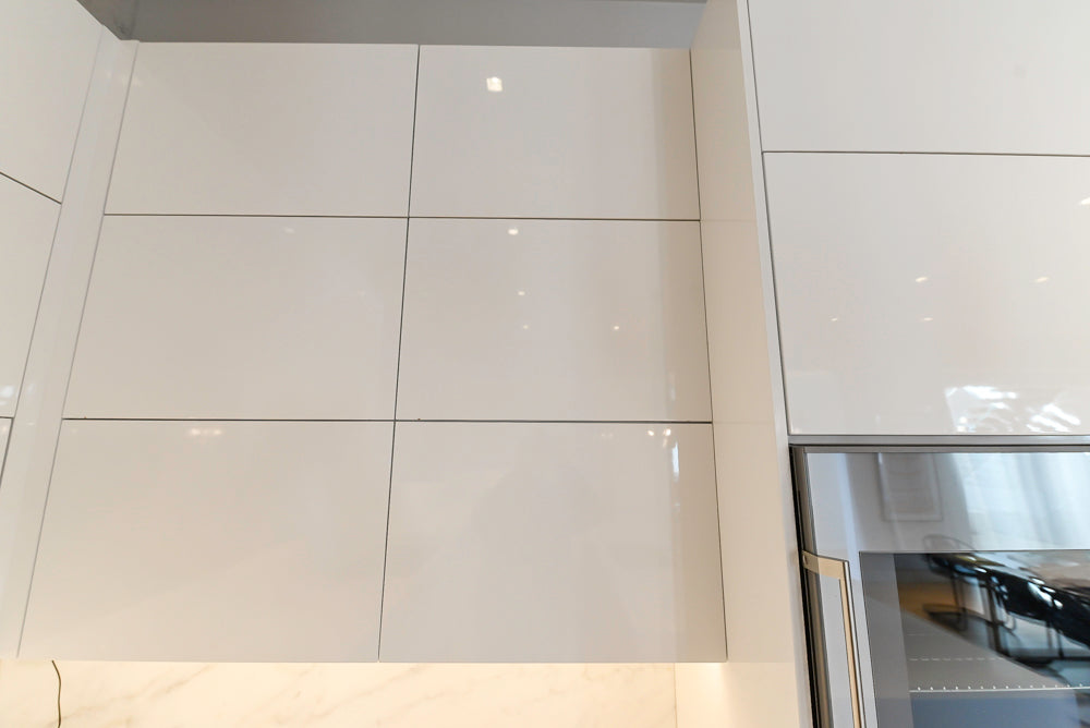 Brubaker Modern White Lacquered Kitchen with Waterfall Island and Stone Countertops