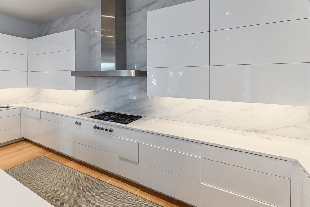 Brubaker Modern White Lacquered Kitchen with Waterfall Island and Stone Countertops