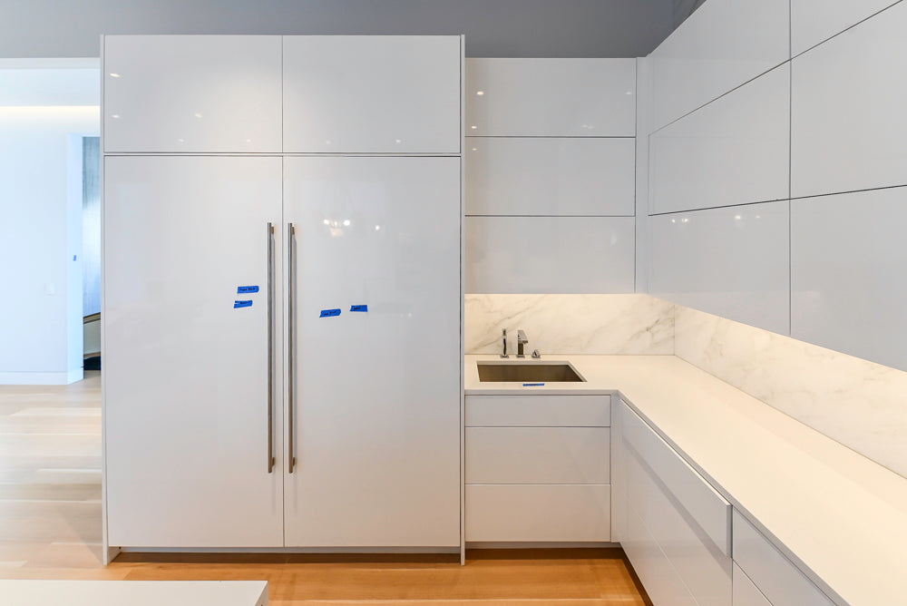 Brubaker Modern White Lacquered Kitchen with Waterfall Island and Stone Countertops