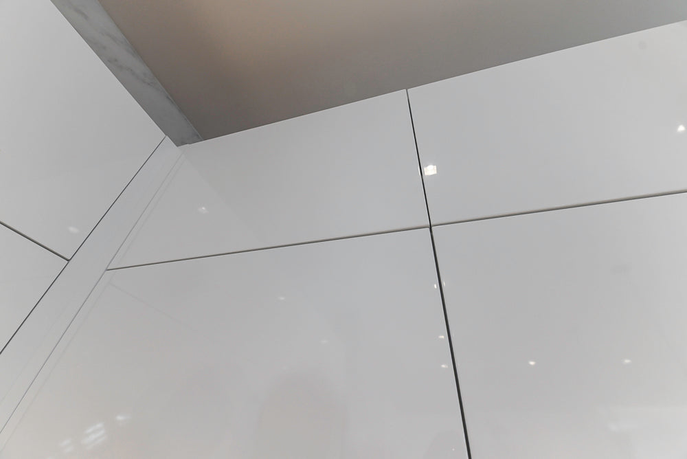 Brubaker Modern White Lacquered Kitchen with Waterfall Island and Stone Countertops