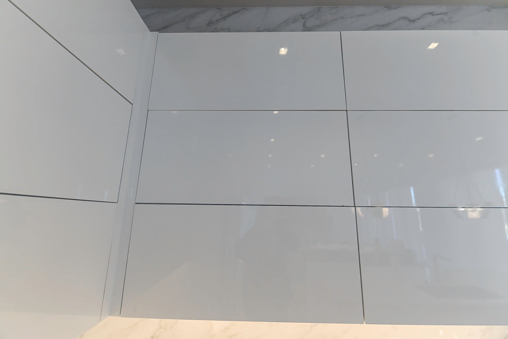 Brubaker Modern White Lacquered Kitchen with Waterfall Island and Stone Countertops