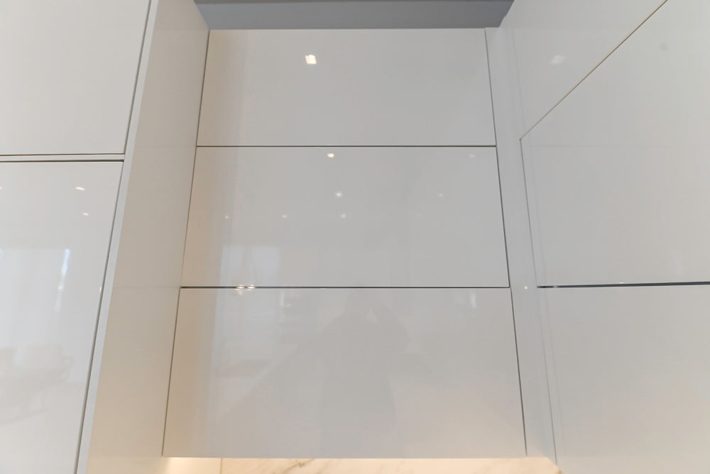 Brubaker Modern White Lacquered Kitchen with Waterfall Island and Stone Countertops