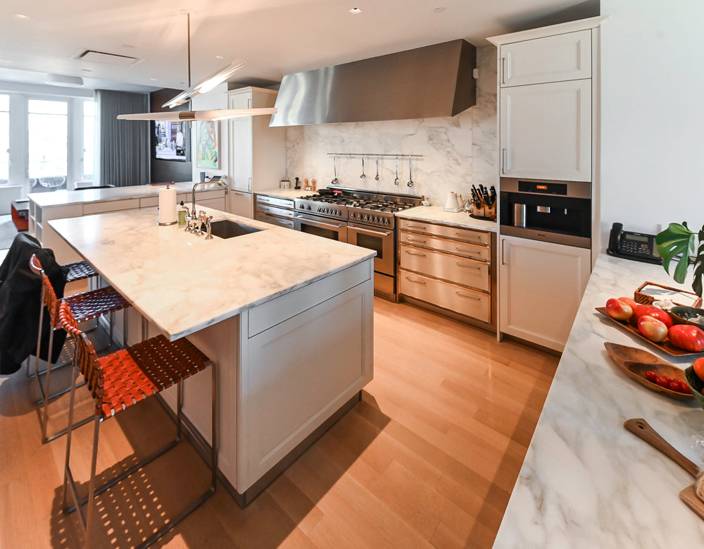 Modern kitchen with marble island and stainless steel appliances