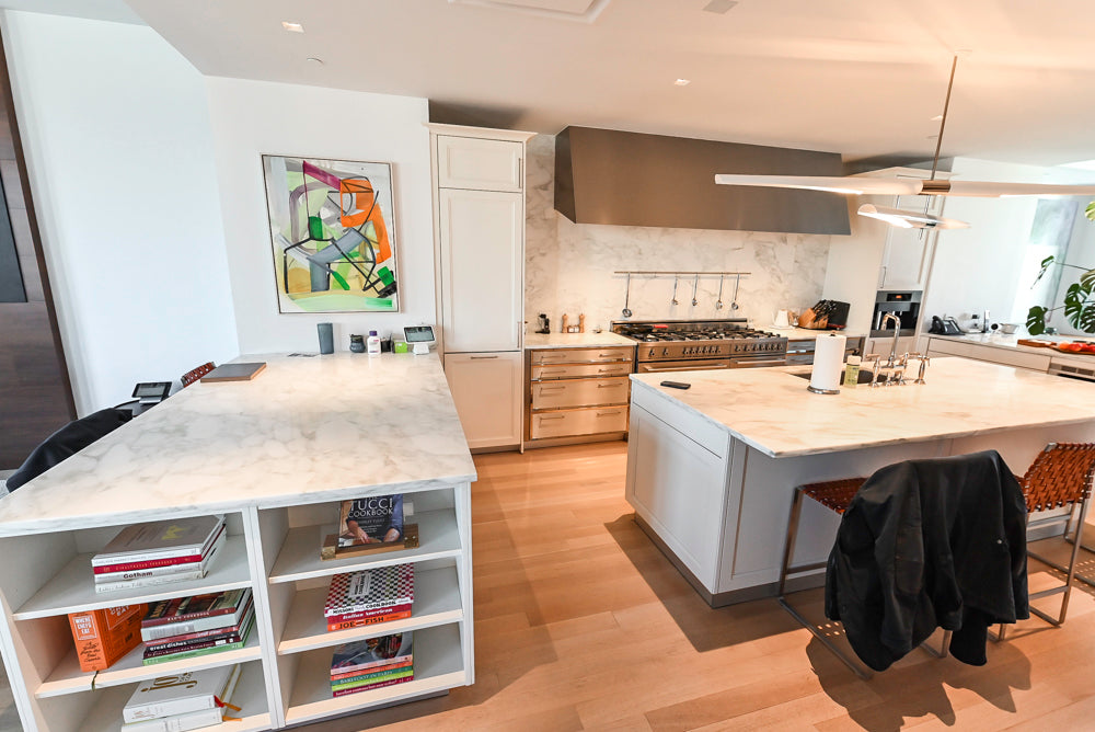 Modern kitchen with marble countertops and stainless steel appliances
