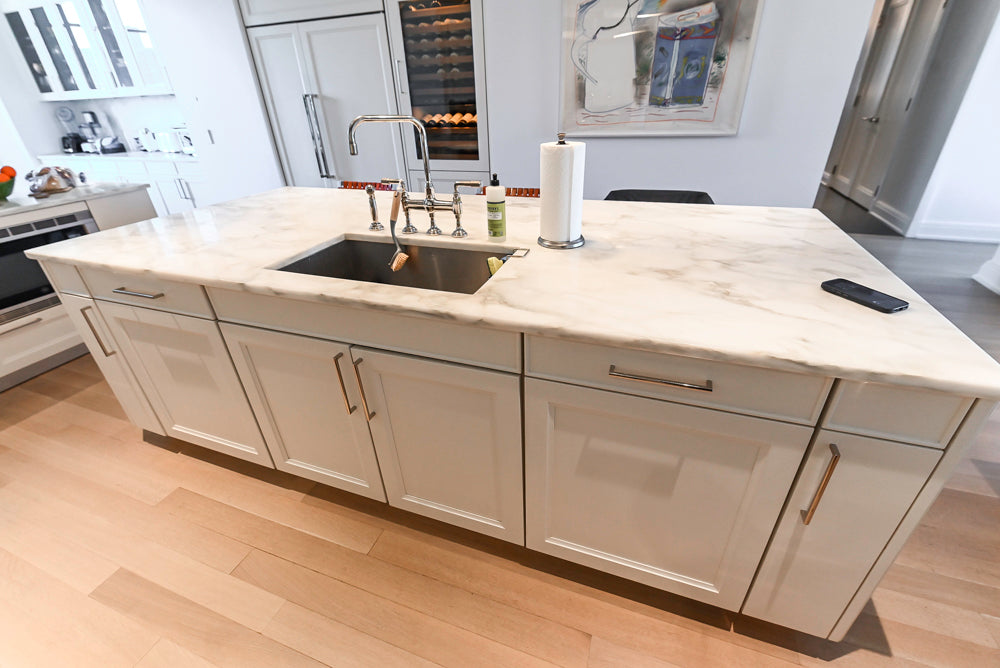 Modern kitchen with marble island and stainless steel sink