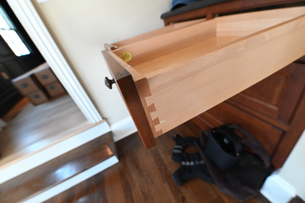 Wooden drawer being pulled out from a cabinet