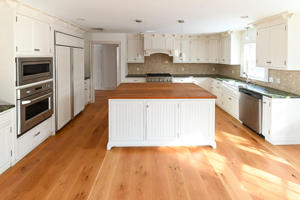 GE Monogram professional appliances integrated into a custom white kitchen