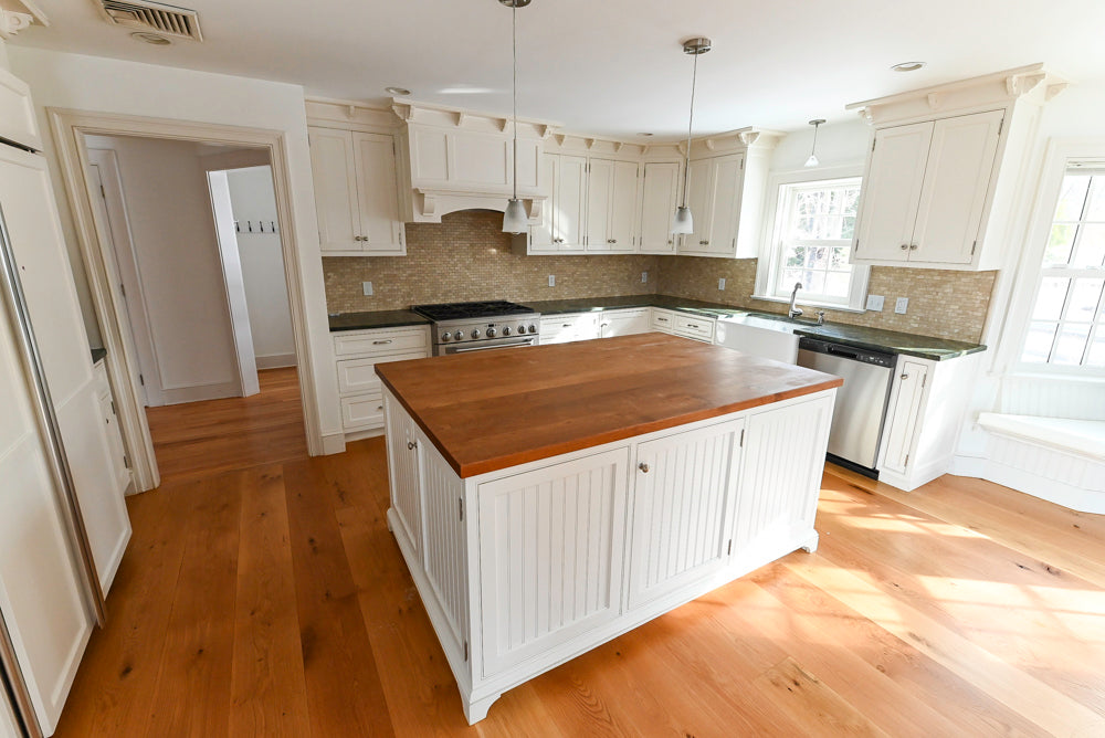 Modern kitchen with wooden island and white cabinets