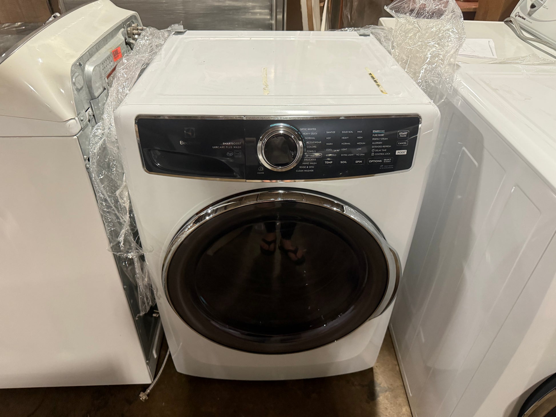 Electrolux 4.5 cubic feet front load washer in white with dark tinted door glass and electronic control panel front view