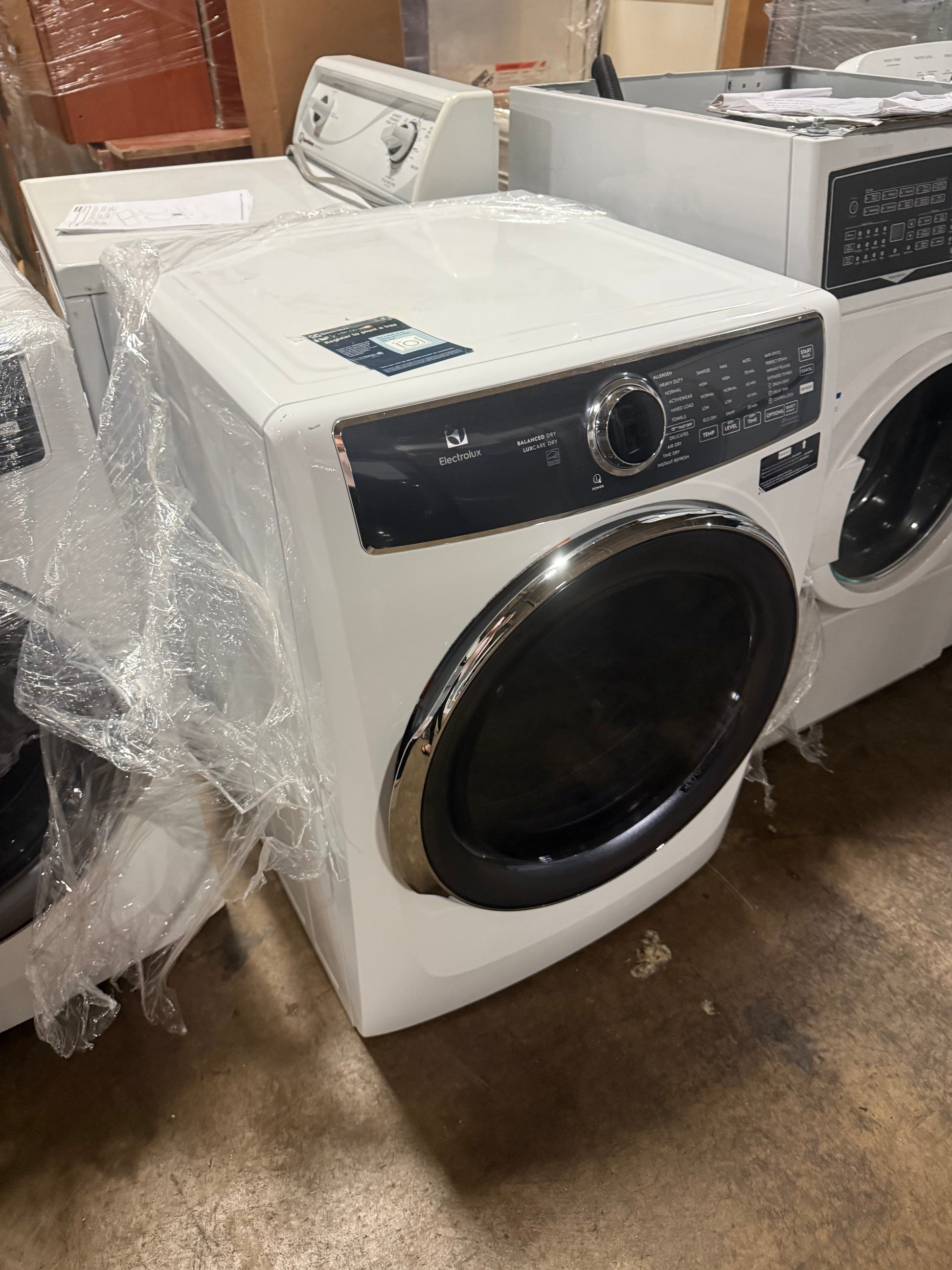 Electrolux front load electric dryer with dual sensor moisture bars visible inside the drum cavity