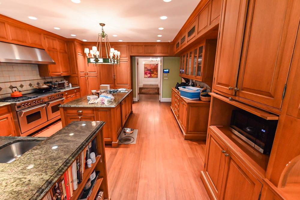 Bespoke solid cherry kitchen cabinets showing dovetail drawer boxes and built in refrigeration panel integrations