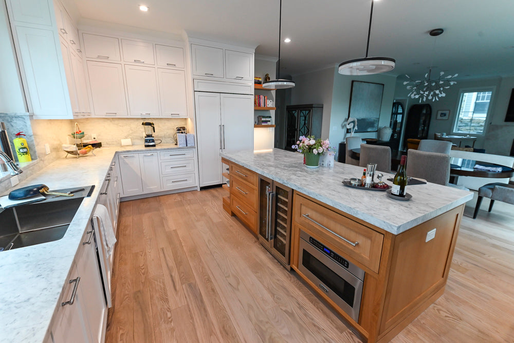 Luxury custom painted white inset cabinets with integrated appliances and wood side pantry