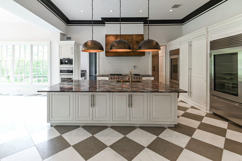Wolf 60 inch dual fuel range with red knobs in custom white transitional kitchen cabinetry surround