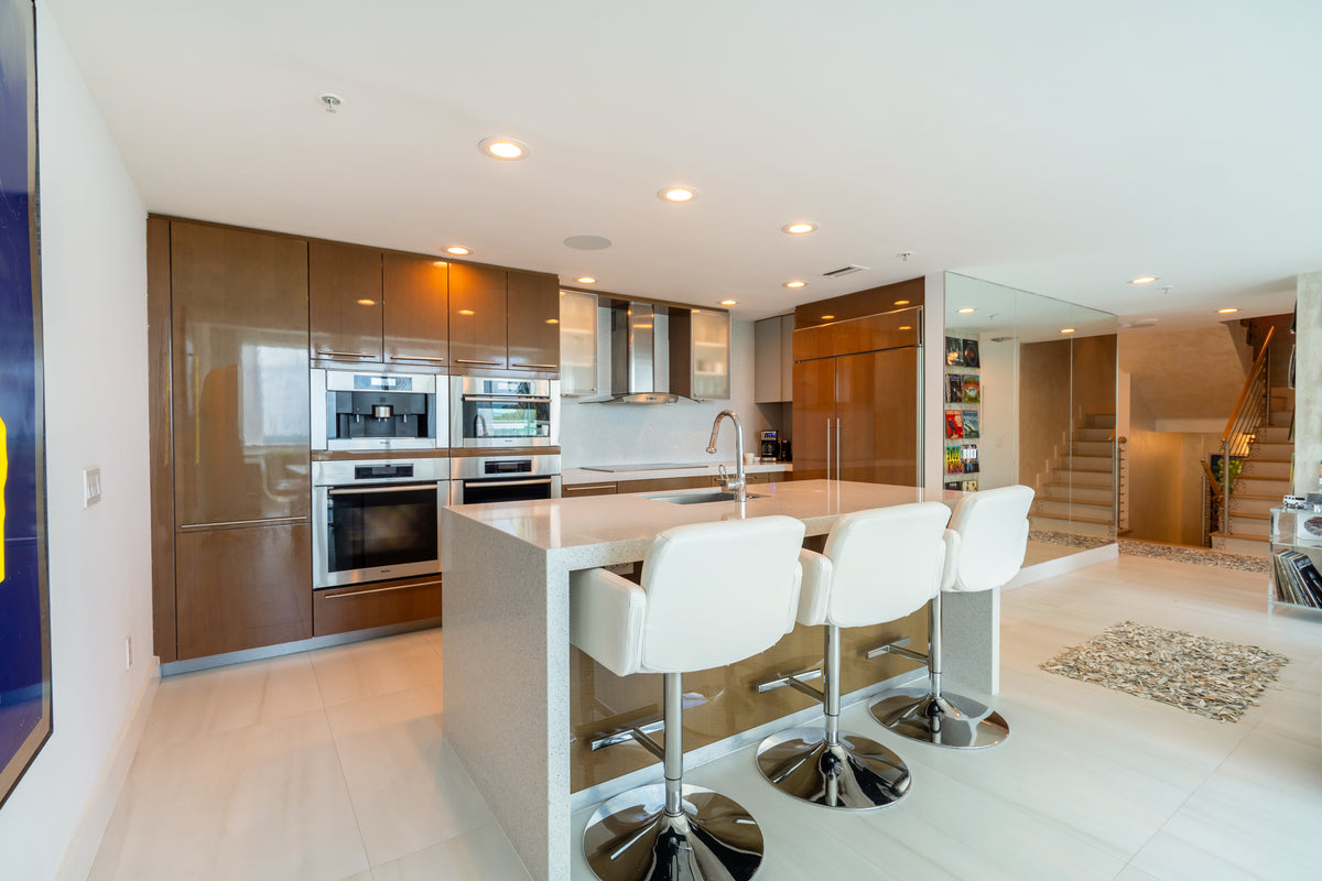 Poggenpohl modern glossy exotic wood veneer kitchen with Miele appliances