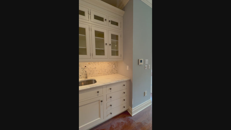 The Clair transitional white solid wood pantry wall cabinets and custom millwork
