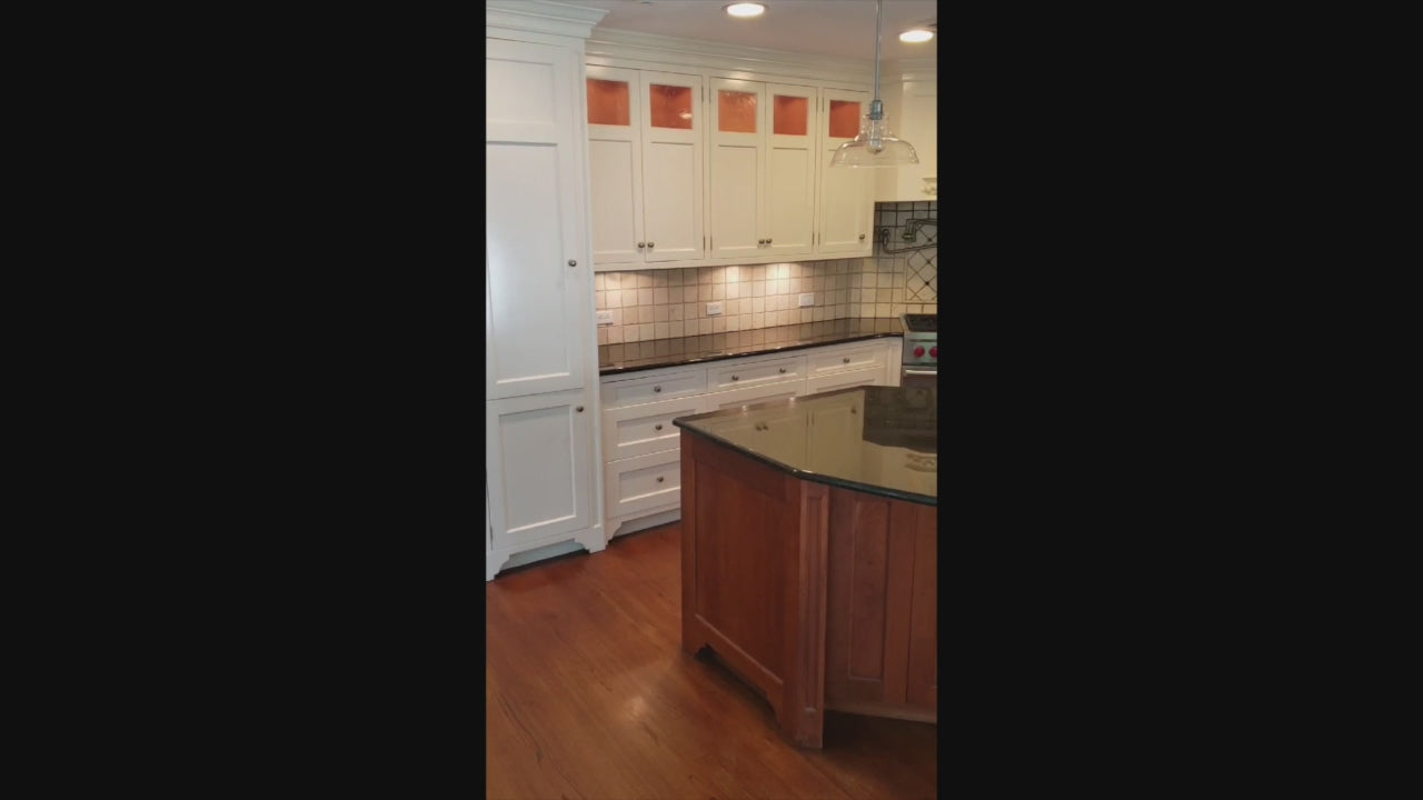 Load video: Custom Traditional White Kitchen with Wood Island, Granite Countertops and Wolf Range
