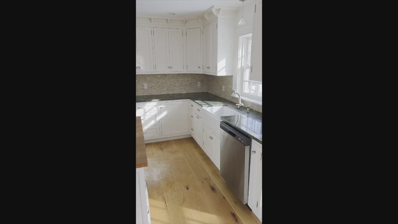 Luxury kitchen island with thick wood countertop and white base cabinets
