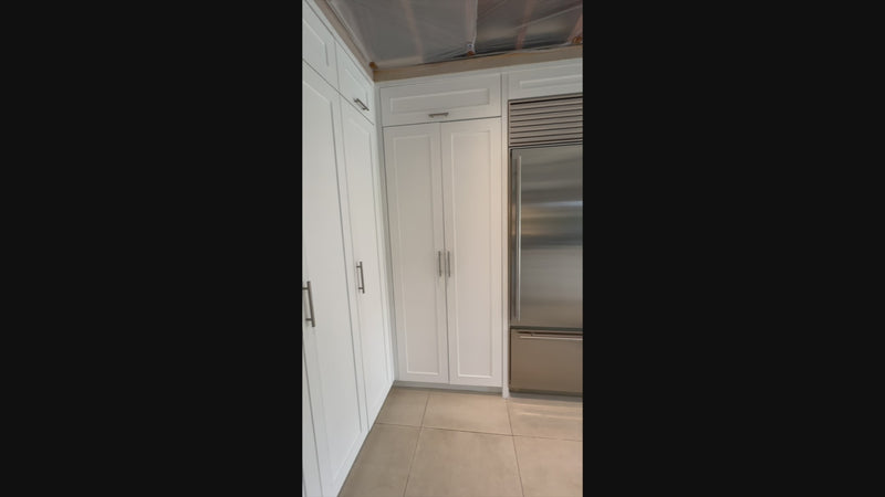 Luxury showroom display custom white kitchen cabinetry and storage layout