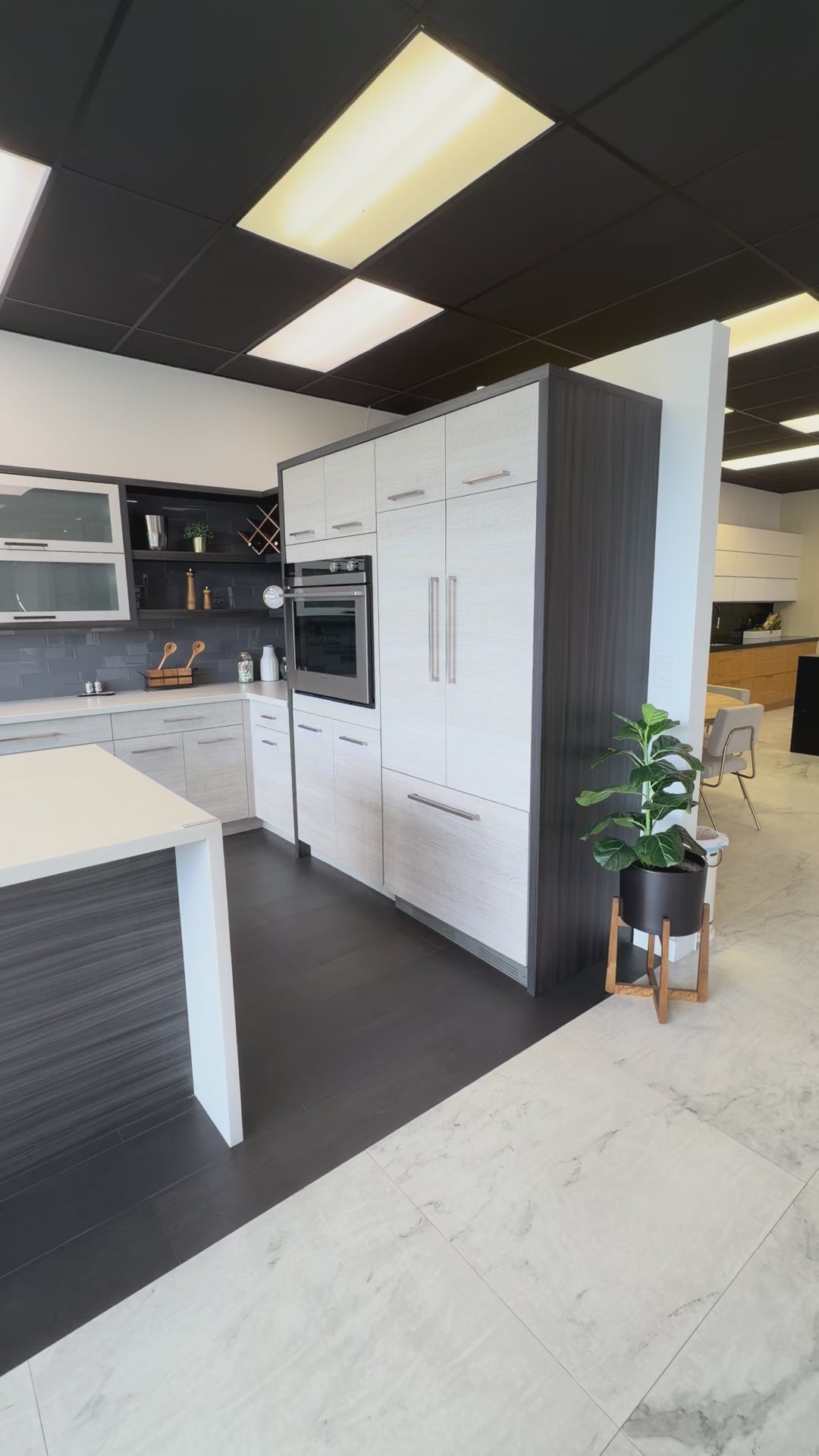 Load video: Bellmont modern wood veneer kitchen cabinets with matching island and appliances