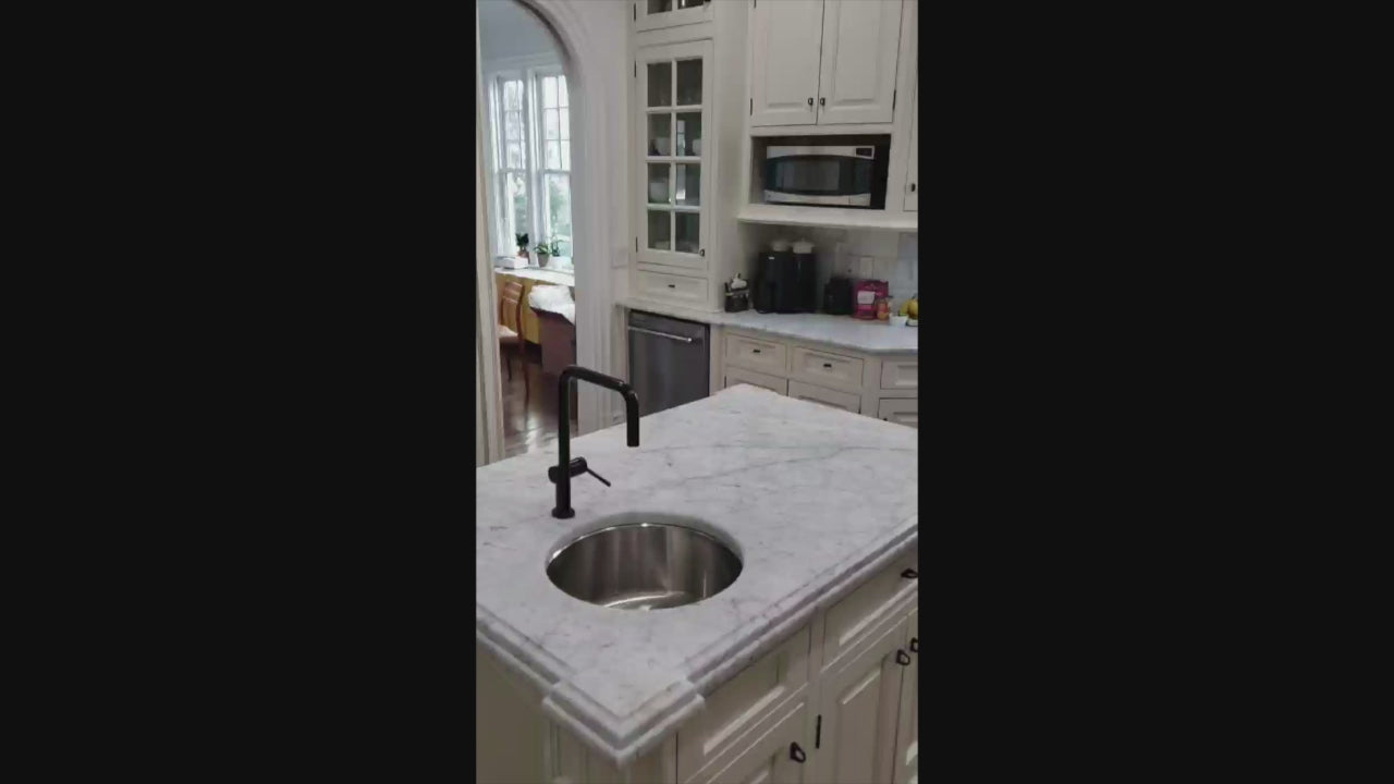 Load video: Traditional Creamy White Kitchen with Island, Marble Countertops and Appliances